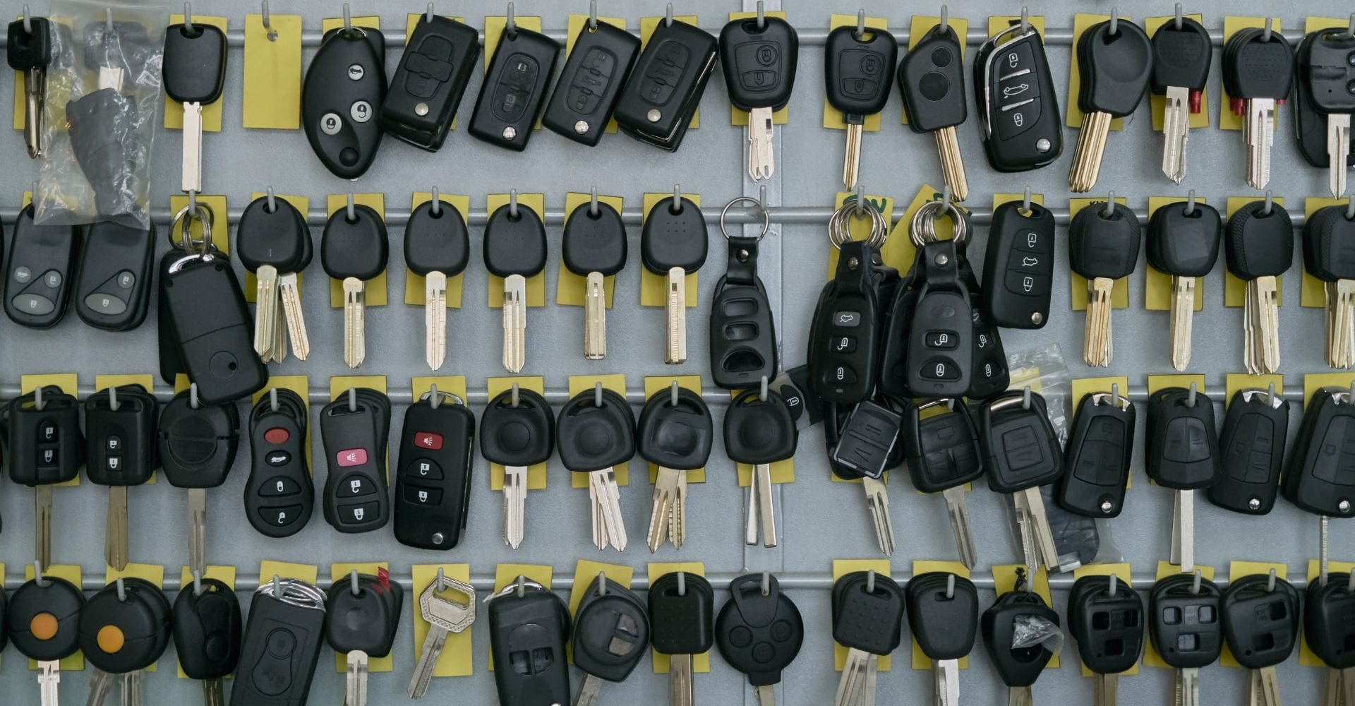 rows and rows of black car keys hanging on the wall