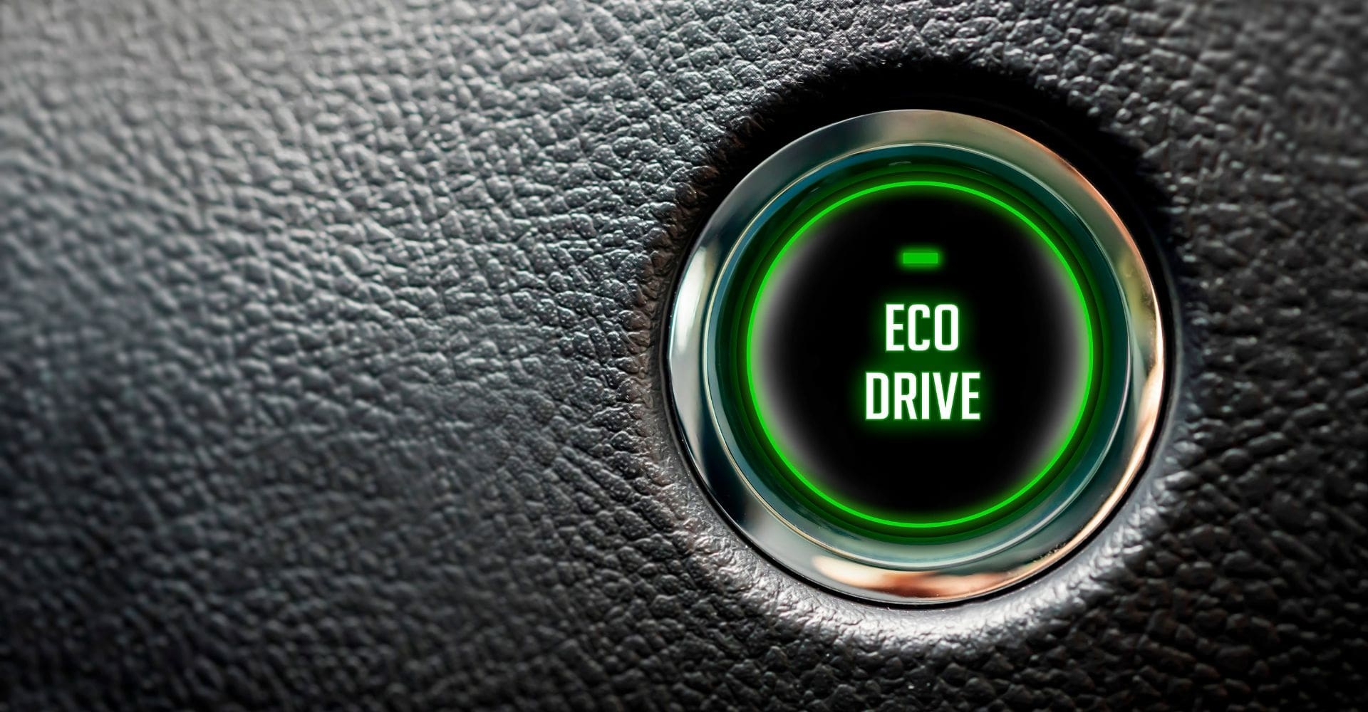 close up if an "eco drive" button on a car dashboard 