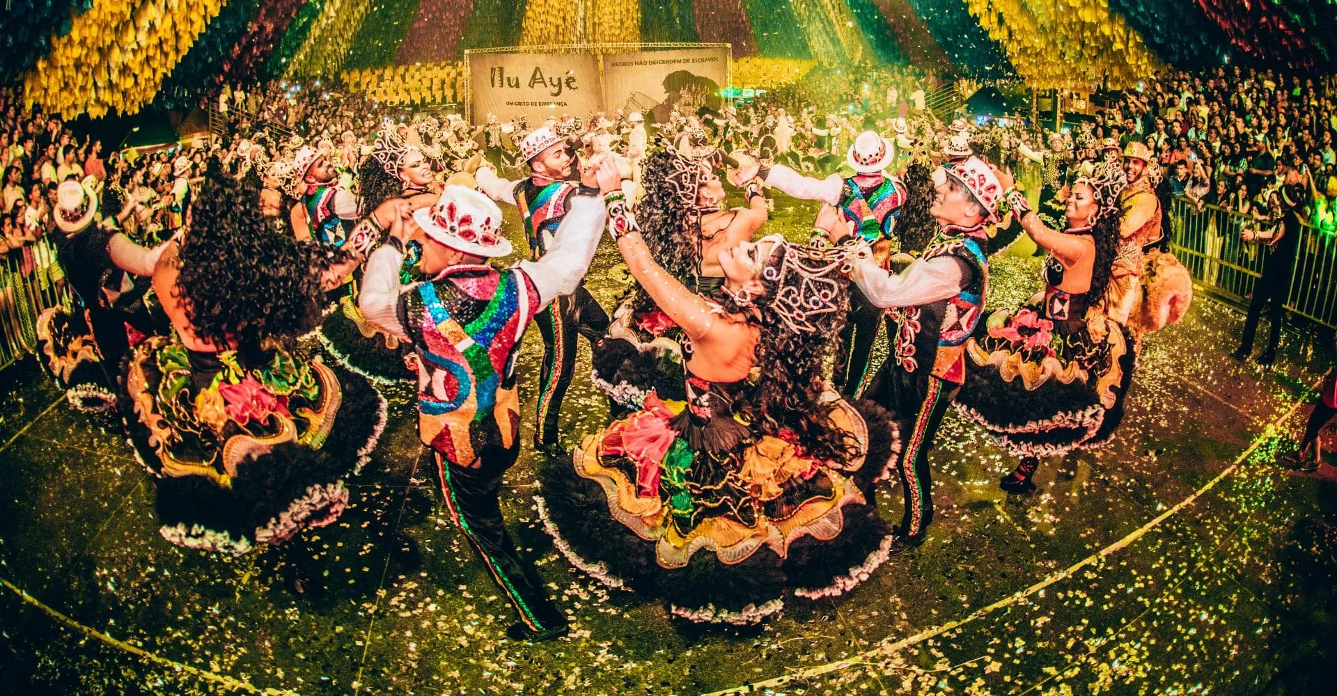 a group of performers dressed in bright colors at a local cultural festival 
