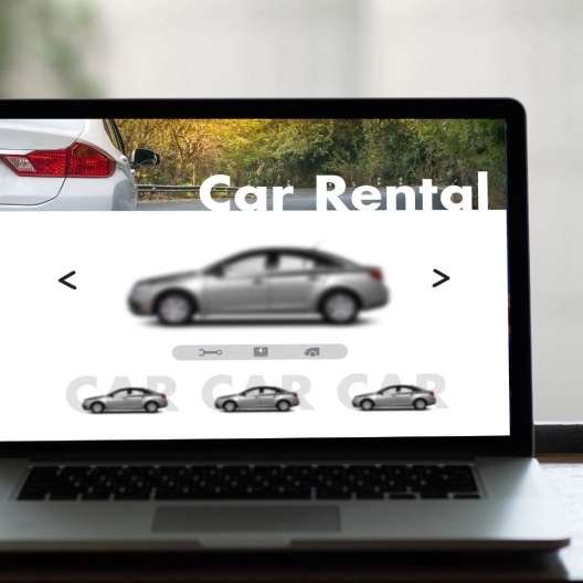 open laptop screen with a website featuring "car rentals" open 