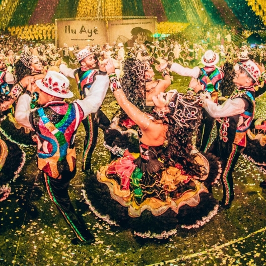 a group of performers dressed in bright colors at a local cultural festival 